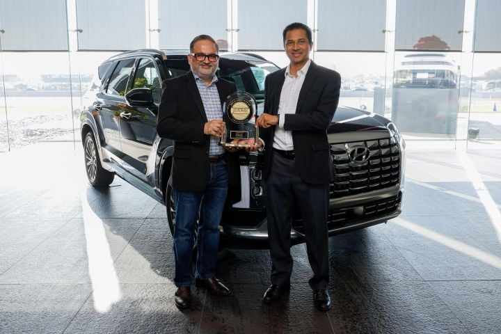 Hyundai Motor North America’s Manish Mehrotra, vice president, digital business planning and connected operations, and Vijay Rao, director, connected operations and owner apps/websites, celebrate...