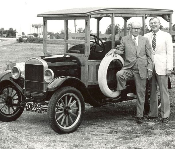 Holman founder Steward Holman, left, with his son Joseph in front of a Model T in this circa 1970s photo. Joseph took over company leadership in 1982 when Steward died. - Holman