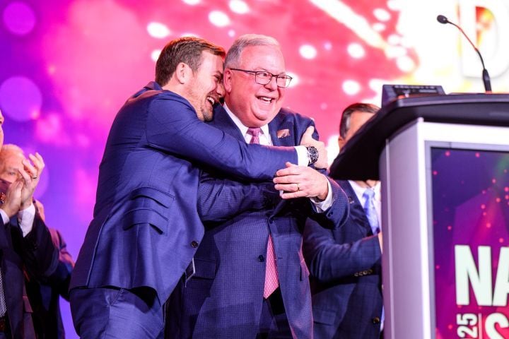 Farabaugh being congratulated on the Time Dealer of the Year award by his youngest son, Daniel. - Ron Bland Photography